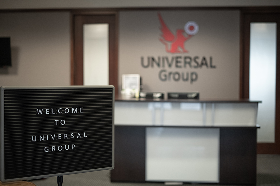 Contact - Universal Group, LTD Front Desk Office View with Background Blurred and Welcome Sign in the Foreground